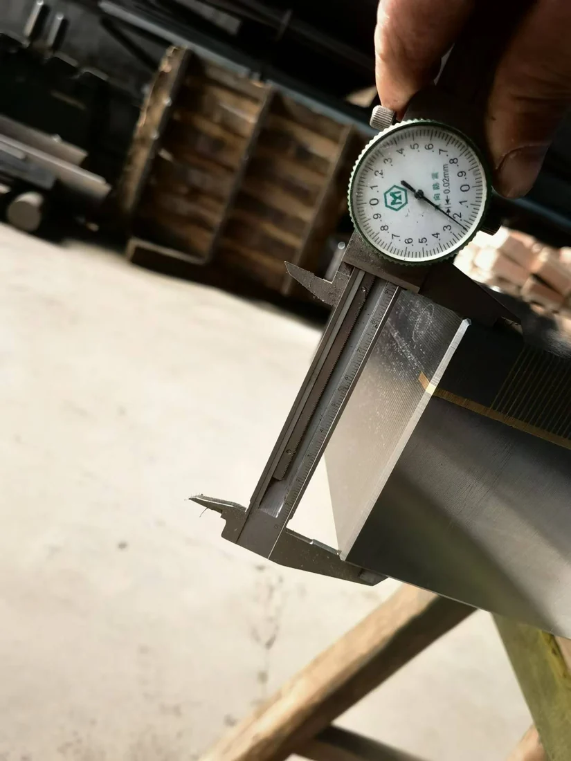 Dial caliper checking a magnetic chuck dimension