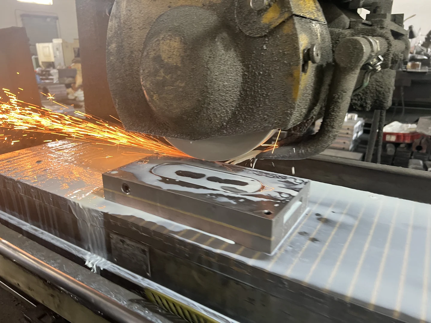Surface grinding a steel component held on a magnetic chuck
